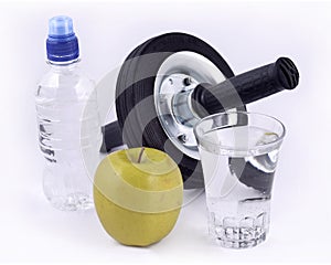 Bottle of water, green apple, glass of water and roller wheel fo