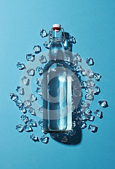 Bottle of water with ice on a blue