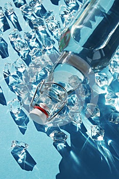 Bottle of water with ice on a blue