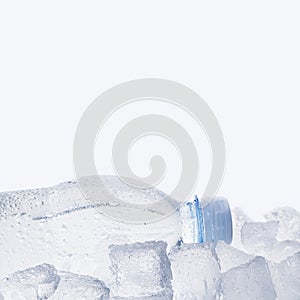 Bottle of water in ice on white background