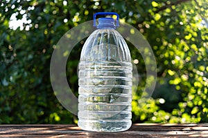 Bottle water made to plastic and green background. refreshing image copy space. 5 liter large plastic water canister