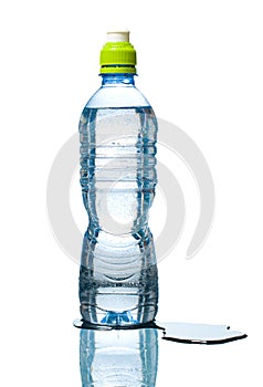Bottle of water with puddle besides