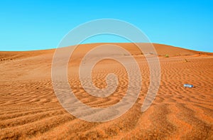 Bottle of water in the sand dunes