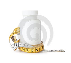 Bottle with weight loss pills and measuring tape