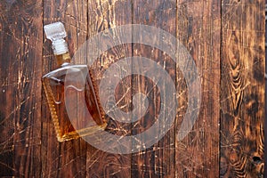 Bottle of whiskey on wooden table