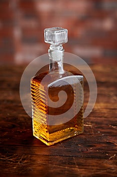 Bottle of whiskey on wooden table