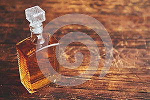 Bottle of whiskey on wooden table