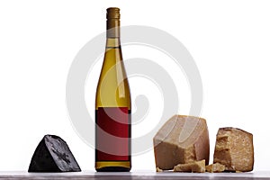A bottle of white wine, expensive cheese, musty cheese, black cheese.