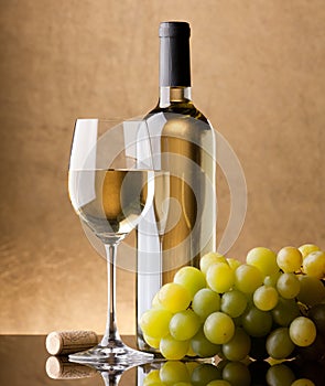 A bottle of white wine, glass