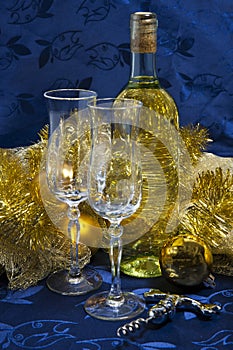 Bottle of white wine, glasses and Christmas decorations