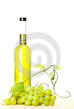 Bottle of white wine and green grapes