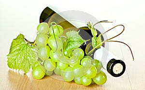 Bottle of white wine and green grapes