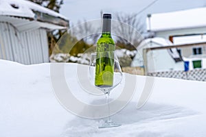 Bottle of white wine inserted in glass