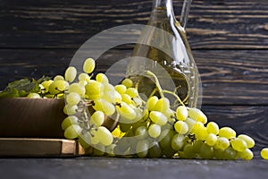 Bottle of white wine, sommelier vintage   natural   celebration grapes on wooden background