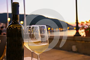 Bottle of white wine and two glasses on the restaurant table