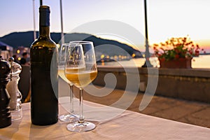 Bottle of white wine and two glasses on the restaurant table