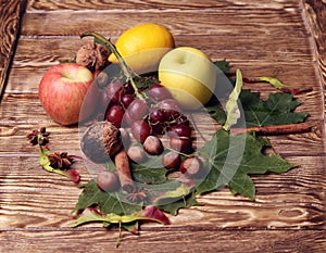 Bottle of wine, glass, leaves, wooden