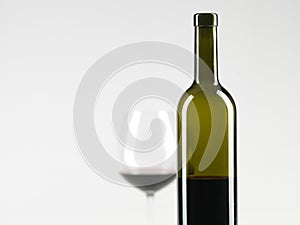 Bottle of wine, glass with red wine