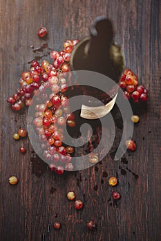 Bottle of wine and grape on wooden background