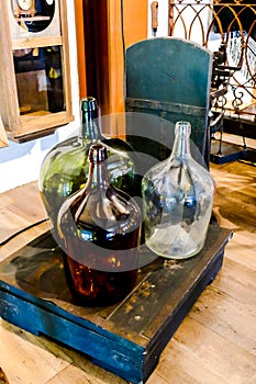 bottle of wine and two glasses on wooden table, in Lisbon Capital City of Portugal