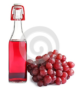 Bottle with wine vinegar and fresh grapes