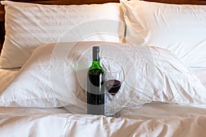 A bottle of wine,  wine glass Ready a party in the bedroom