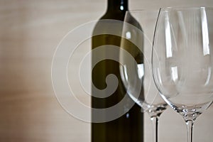 Bottle of wine and wine glass stemware in the simple interior