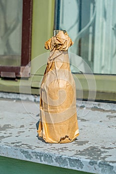 Bottle in paper bag photo