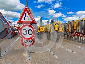 Bottleneck road narrowing speed limit sign photo