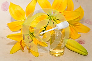 Bottles of aromatic oil and lily flower