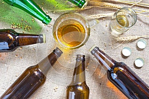 Bottles of beer, mug of beer and wheat on sacking