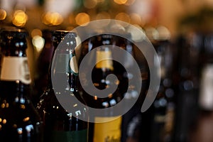 Bottles of beer stand in the background of the blur pub in the evening