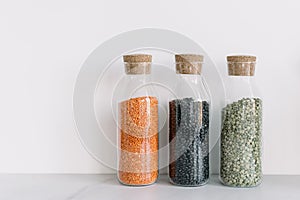 Bottles with cereals in modern trendy kitchen