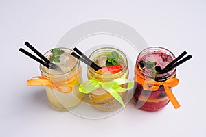 Bottles of cold lemonade with lemon slices and straws