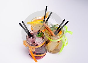 Bottles of cold lemonade with lemon slices and straws