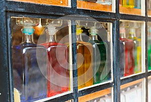 Bottles with colored liquid on the window