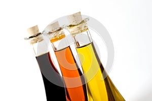 Bottles of coloured oils isolated on white