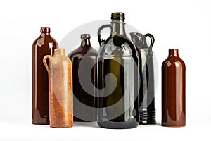 A composition of various dark bottles on a white background