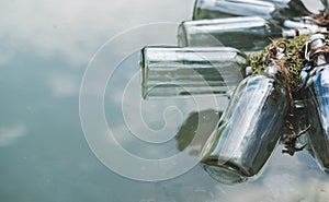 Bottles connected with notes inside float by the lake. Quests, games, adventures