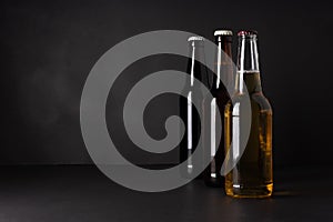 Bottles with craft beer on a black background.  Ale or lager from pilsner malt.  homemade home-brewed beer