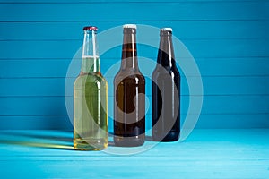 Bottles with craft beer on a blue background.  Ale or lager from pilsner malt.  homemade home-brewed beer
