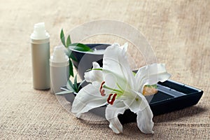 Bottles of creams/lotions with lilies