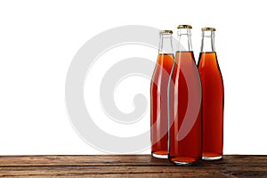 Bottles of delicious kvass on wooden table