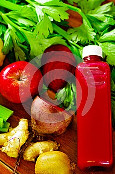 Bottles of delicious organic juice lying on desk sorrounded by fruits and veggies, beautiful colors, healthy lifestyle
