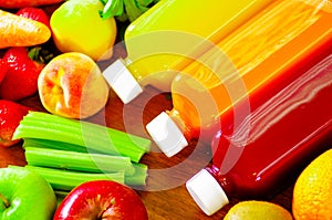 Bottles of delicious organic juice lying on desk sorrounded by fruits and veggies, beautiful colors, healthy lifestyle