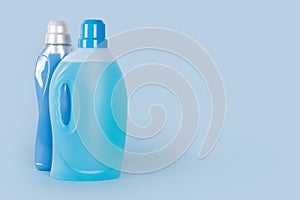 Bottles of detergent and fabric softener on blue background. Containers of cleaning products, household chemicals