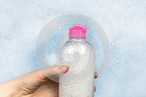 Bottles of detergents float in the foam. The concept of the dangers of household chemicals. Sodium laureate, parabens, sulfates