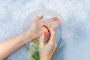 Bottles of detergents float in the foam. The concept of the dangers of household chemicals. Sodium laureate, parabens, sulfates