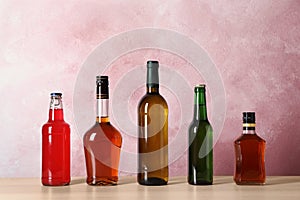 Bottles with different alcoholic drinks on table