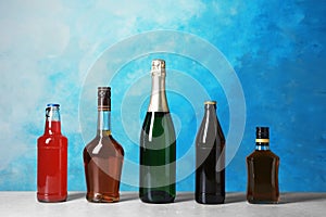 Bottles with different alcoholic drinks on table